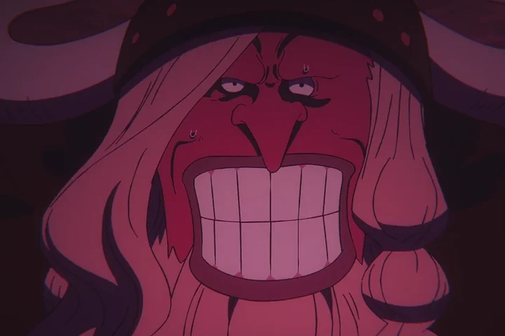 Broggy transformado em uma forma demoníaca, com olhos brilhantes e dentes expostos, sob uma iluminação magenta.